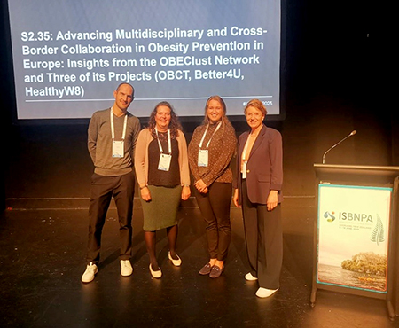 Group of four researchers on stage at ISBNPA 2025 conference, after presenting on cross-border collaboration in obesity prevention in Europe.